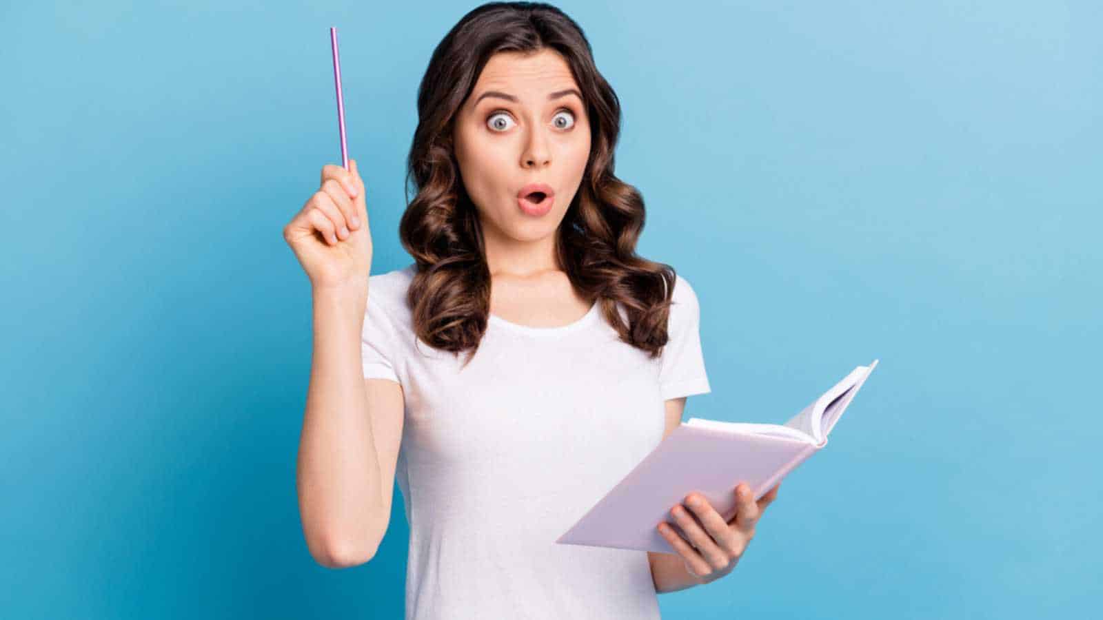 Woman with book astonished