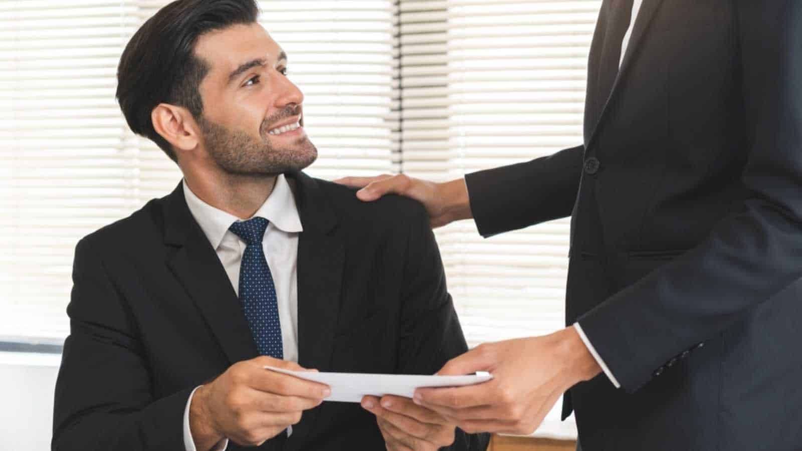 Good job, asian manager man giving financial reward in an envelope, business letter extra salary to company employee, caucasian male worker office hand received premium bonus, getting cheque from boss
