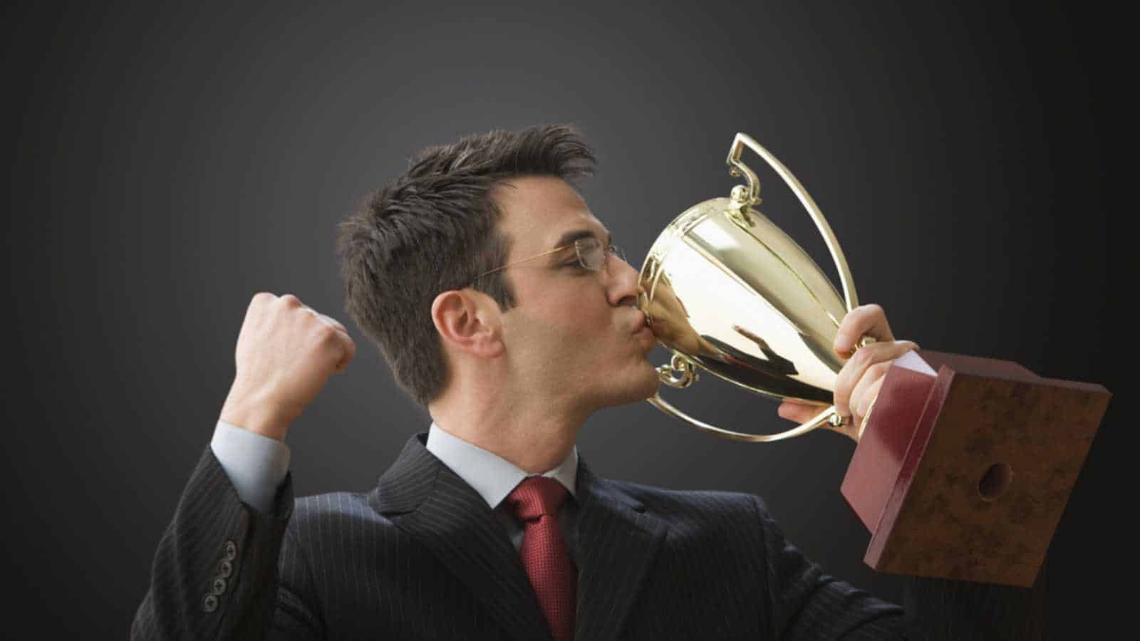 Man kissing trophy