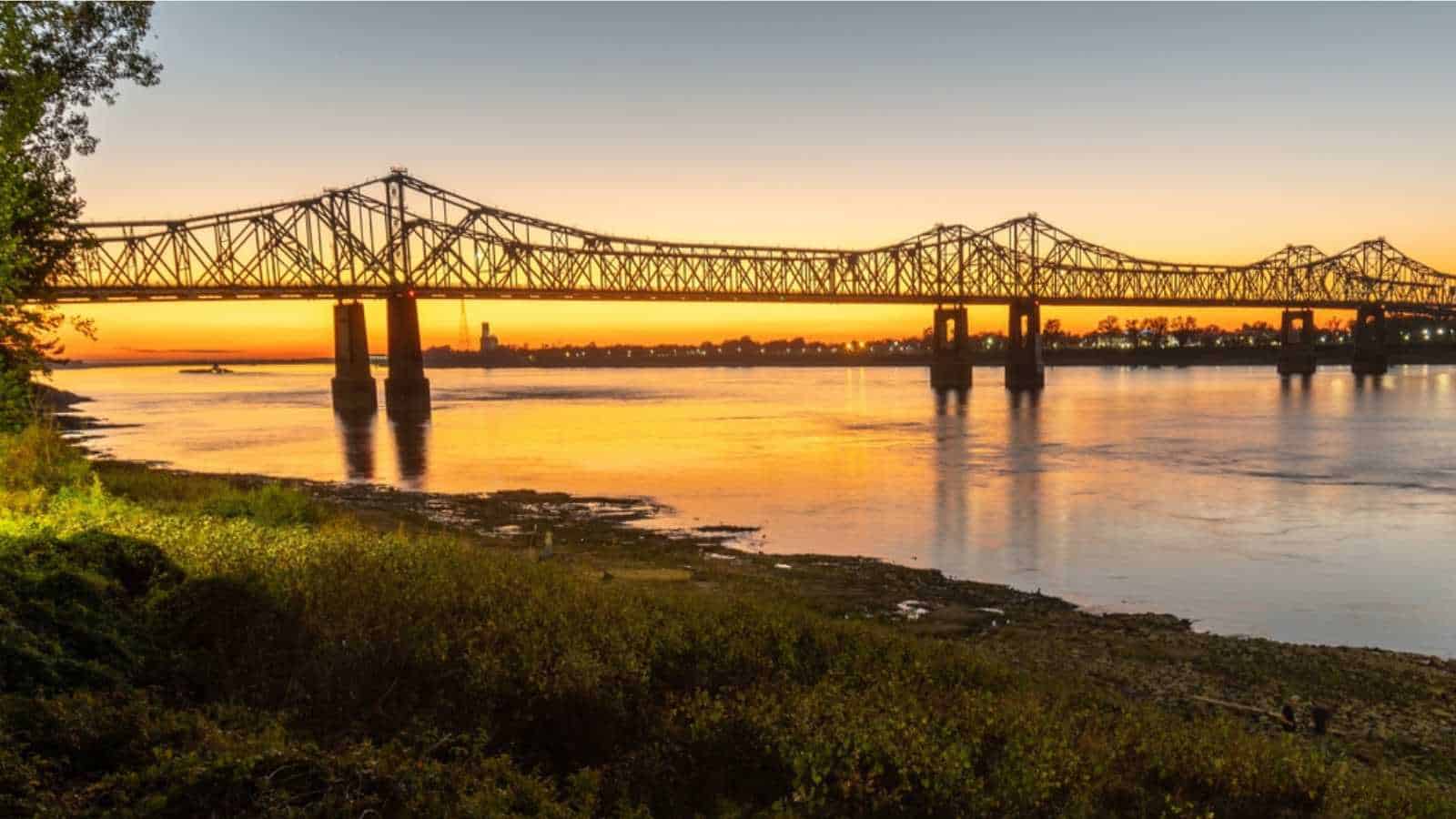 Sunset on the Mississippi River in Natchez, Mississippi with the Natchez Vidalia Bridge.
