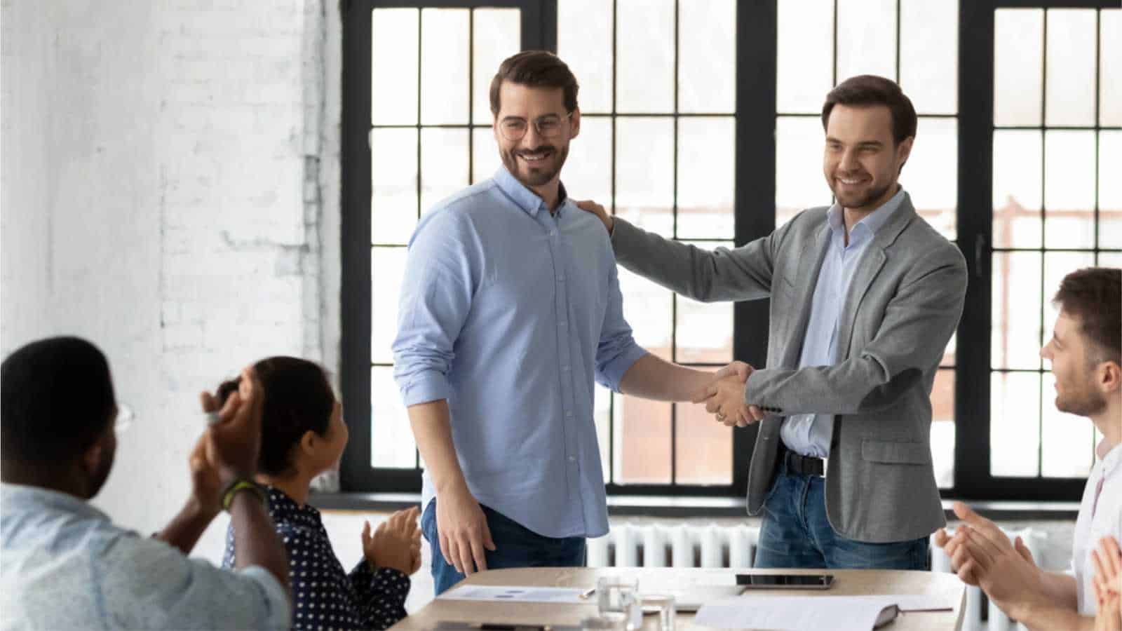 Proud boss encouraging and thanking happy employee