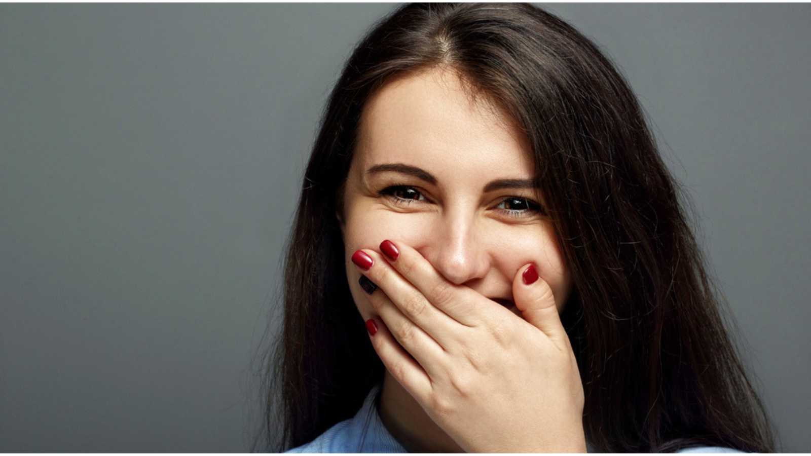10 Most Astonishing Contractual Loopholes in History 46 Woman laughing and covering mouth