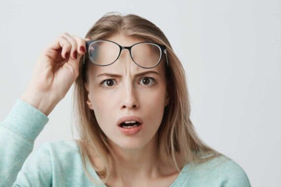 Woman shocked and removing specs
