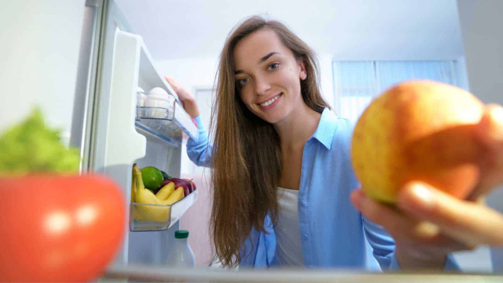 Woman taking from fridge