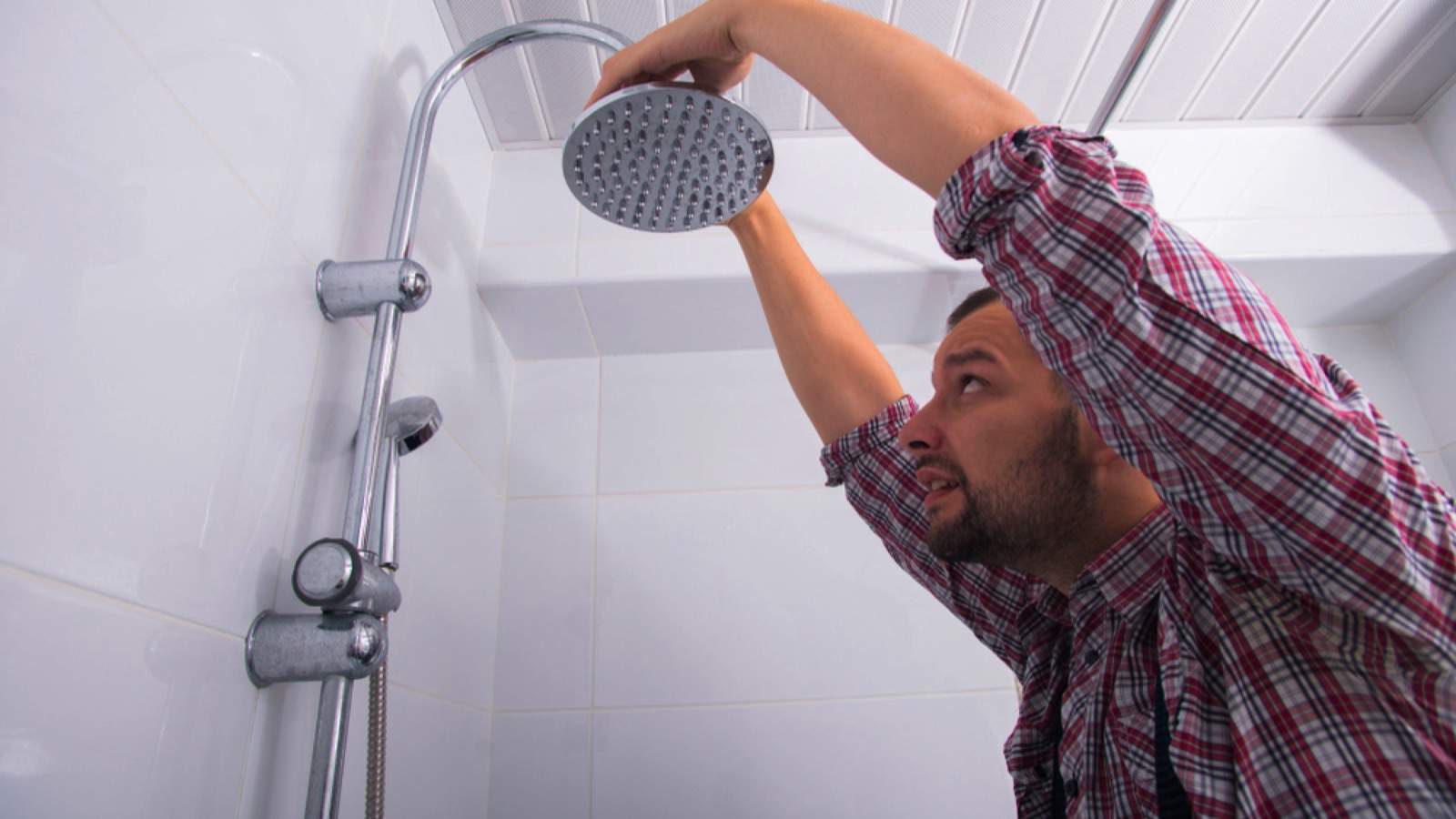 Man fixing showerhead