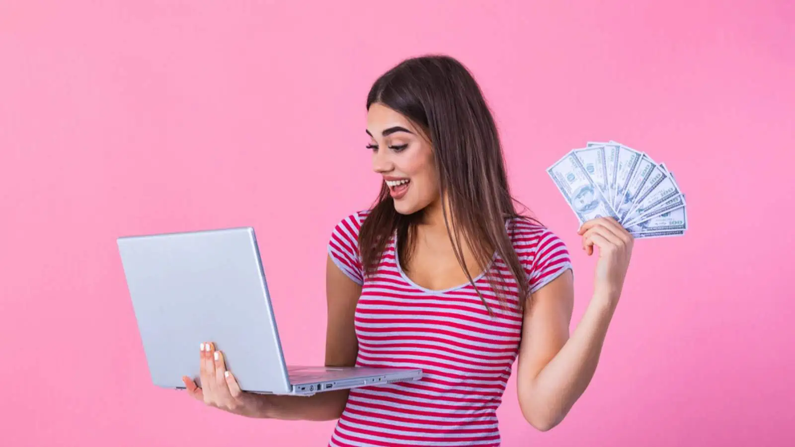 Woman with money and laptop