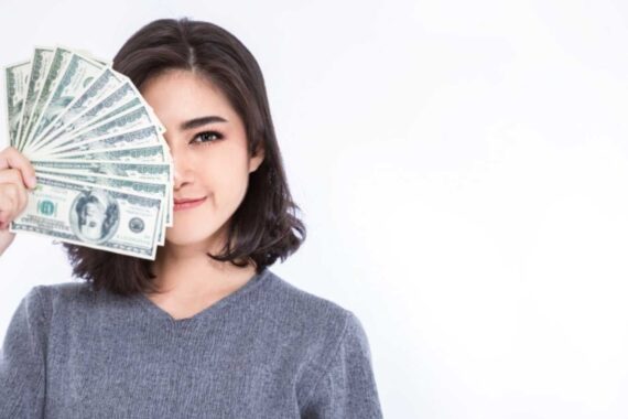 Woman with money covering face