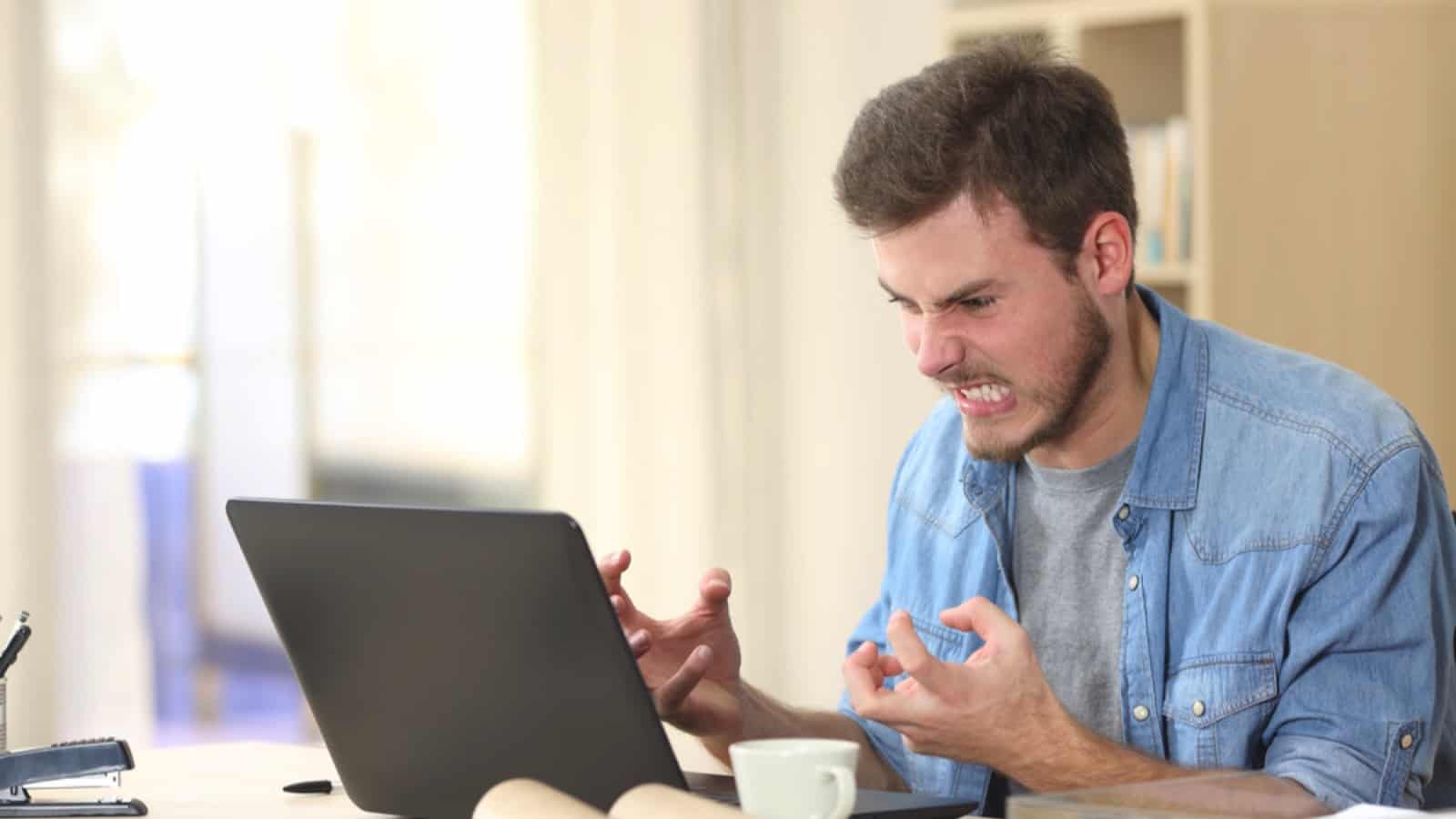 Angry and furious man working in office