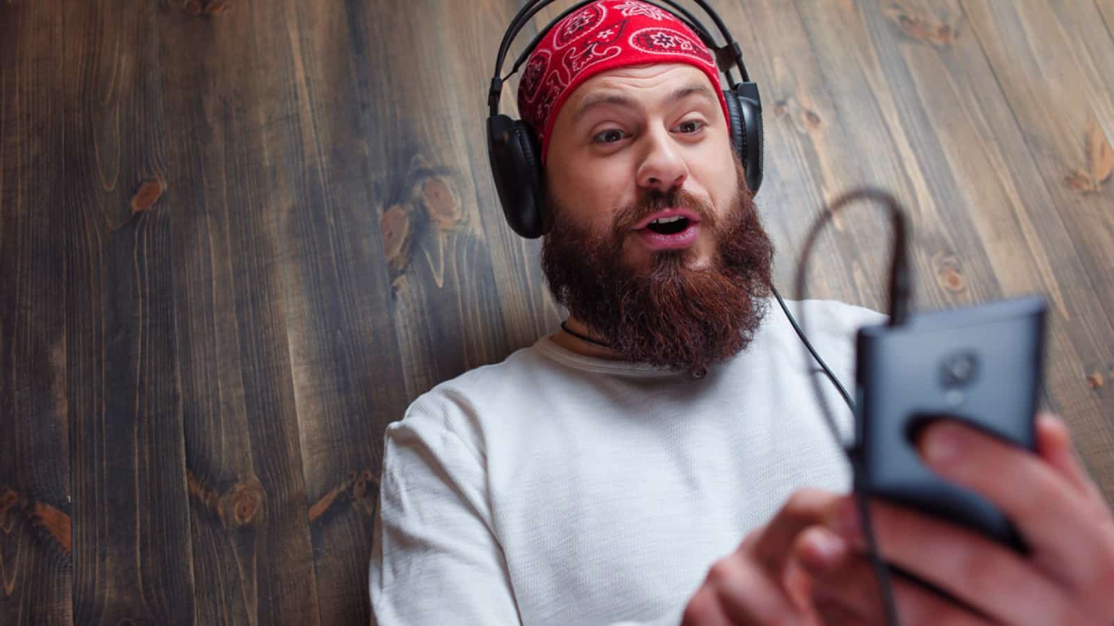 Bearded man hearing music
