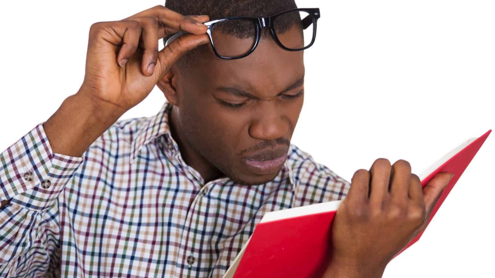 Man with surprised and shocked look reading book