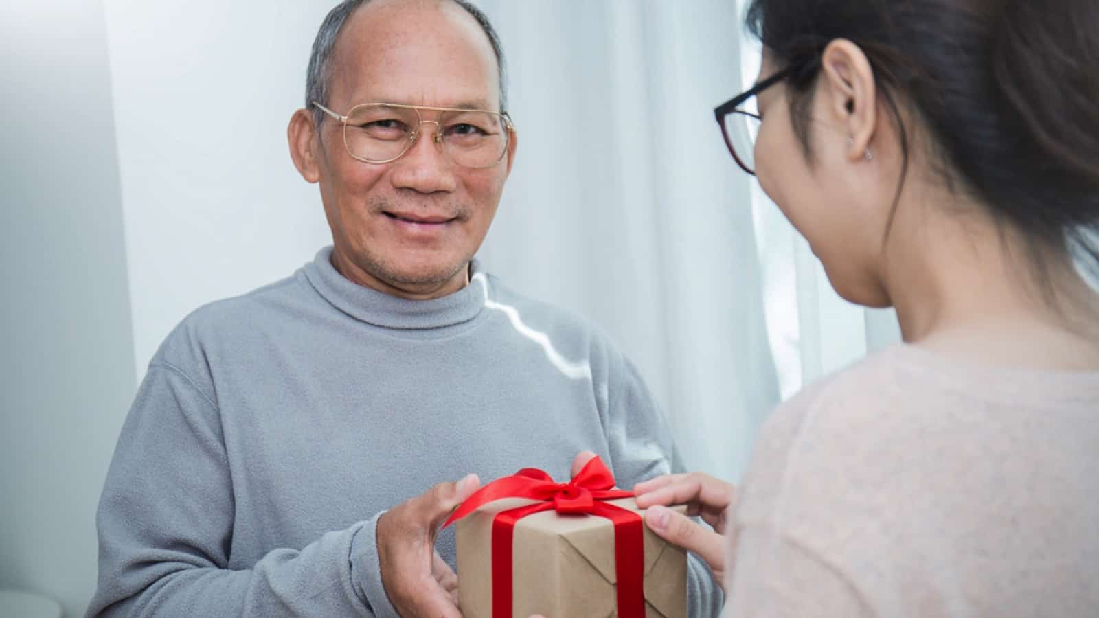 Old man gifting to teen girl