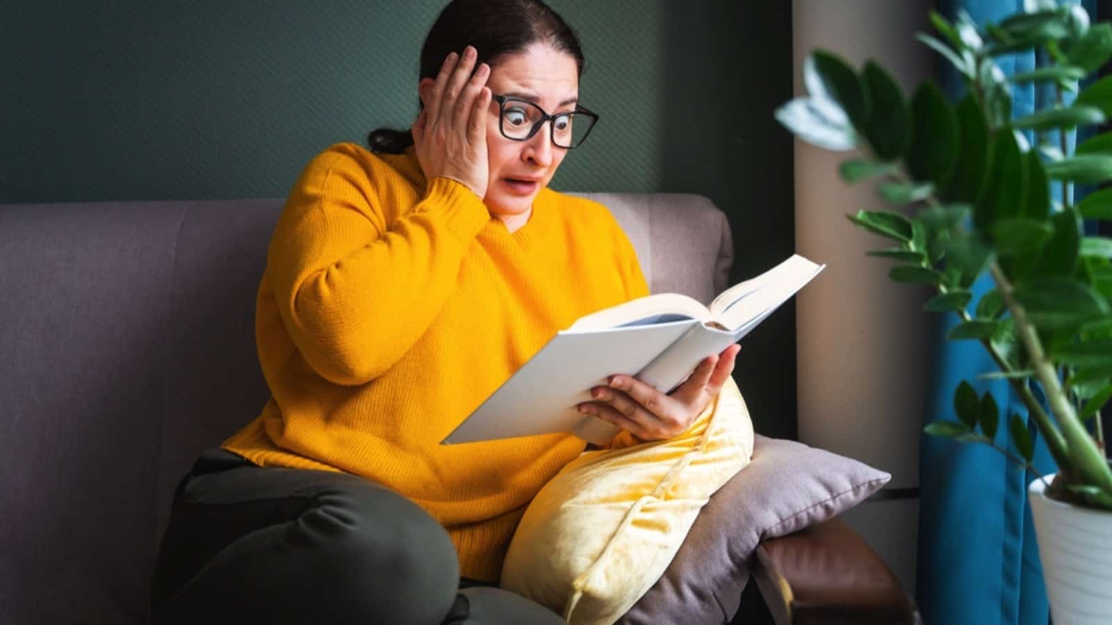 Woman reading book scared