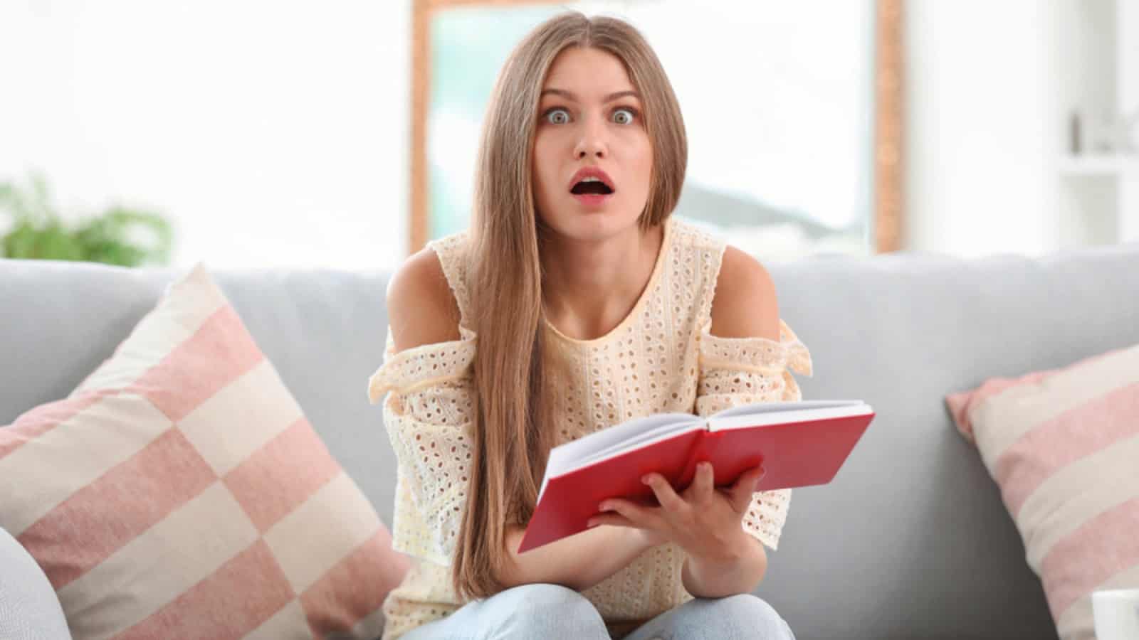 Woman terribly shocked reading book