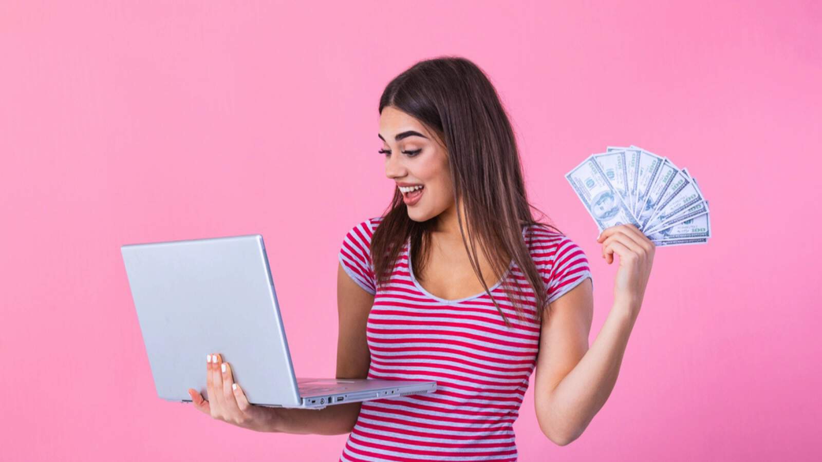 Woman with money and laptop