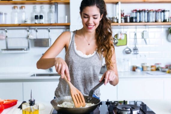 Young woman cooking in kitchen