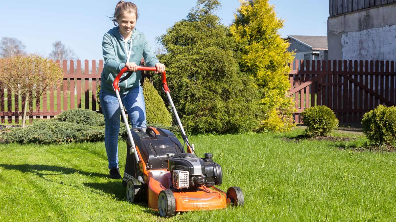 teen mowing lawn