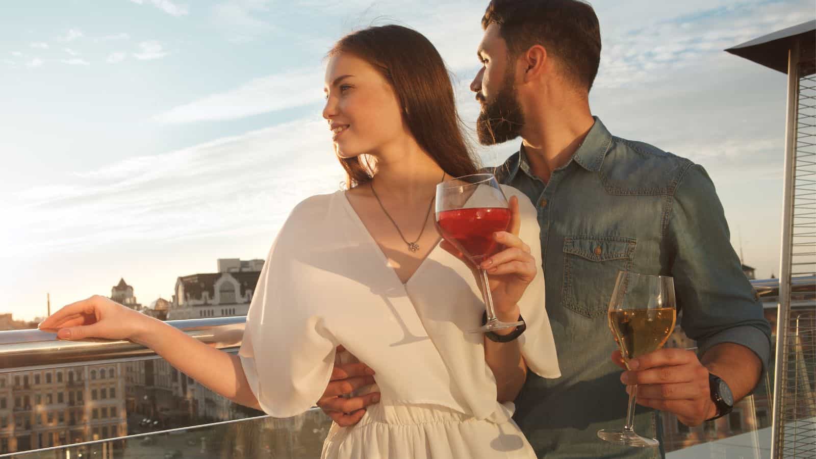 couple drinking wine balcony