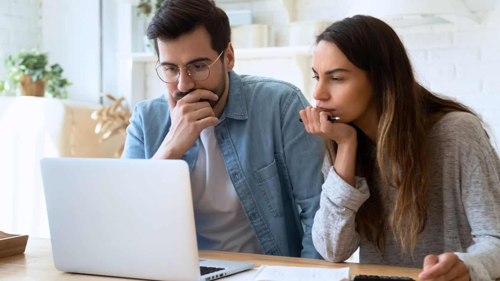 couple looking online laptop