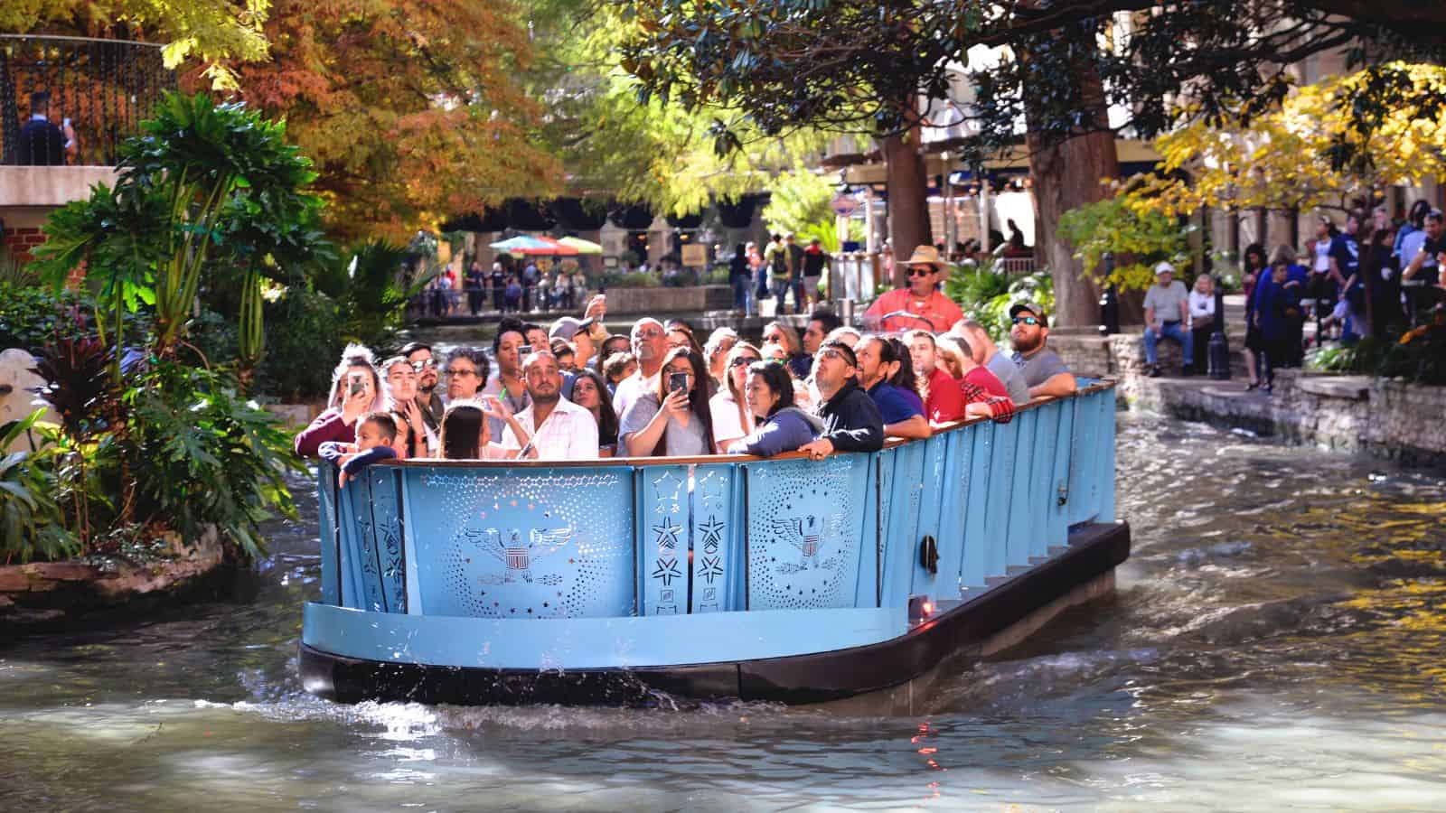 people enjoying the riverwalk in san antonio